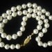 RESERVED for V. SALE Vintage Pearl Necklace 21 inches long with gold tone filigree clasp. Glass pearls.