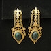 RESERVED for V. Vintage Gold Chandelier Earrings with Green Oval Cabochons, chains, and Fleur de Lis Accents