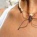 wire butterfly necklace with white macramé braid