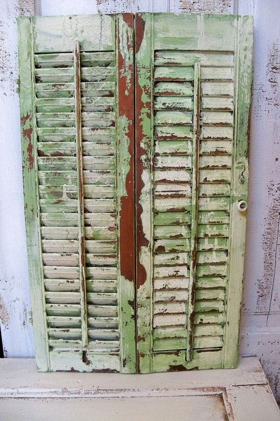 Shabby garden green wooden shutter heavily distressed home and