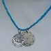 Necklace lotus flower and black and silver mandala medallion on hand dyed blue silk chord