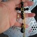 large beaded JET BLACK CROSS pendant & gold plated chain.