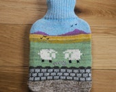 Knitted hot water bottle cover with countryside design: bottle included
