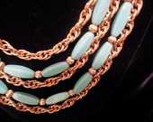 Napier Necklace Turquoise , made of plastic, with gold scored beads in between each piece, three strands, alternating turquoise, and gold