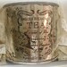 vintage silver plated english breakfast tea tin . round with engraving . much patina . antique reproduction