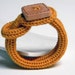 Mustard yellow knitted wool yarn bracelet Noemi, handmade square wood button, knitting jewelry.