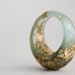 sea green and gold multifaceted eco resin ring with suspended gold flakes