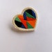 Mini geometric heart pin with green orange black blue and red colorblock