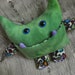 Wibbly Woo - a stuffed plush pocket monster in a mottled green