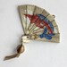 Folding fan pendant with asian design and tassel