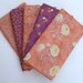 Set of five fat quarters in orange and purple prints