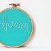 Embroidered Hoop Art. "Dream" Teal Fabric and Blue Thread. Embroidered Fabric Wall Hanging. Nursery Decor by merriweathercouncil on Etsy