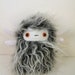 Clammer the horned plush monster white and grey stuffed animal