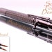 Handcrafted, gunmetal plated, 30 cal bullet pen with stainless steel braid. Bolt action ink advance. Very cool.