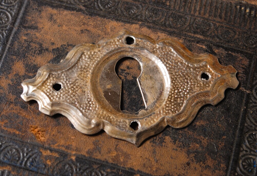 Vintage metal key hole escutcheon plate finding