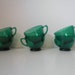 collection of six emerald green cups . old green glass cups