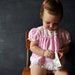 Cute light pink swiss dot baby dress/top with rosettes and white lace trim, size 12 months