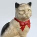 vintage cast iron black and white cat with a red bow bank offered by Elizabeth Rosen