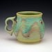 Large mug with ergonomic two finger handle.