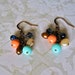 rustic copper beaded cluster earrings. peach coral mint green beads. cream bronze freshwater pearls. navy blue beads.