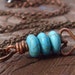 Blue Moon necklace. turquoise stones and copper shaped heart hangs from a delicate brass cable chain.