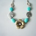 Turquoise flower necklace with gems, flowers and leaves