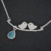 birds on branch silver necklace - with light blue gem