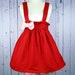Hello Kittys Red Pinafore with a Baby Pink Bow size Med