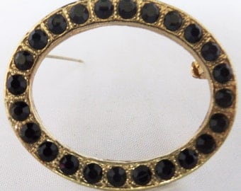 Vintage jewelry brooch in black rhinestone and gold tone circle brooch