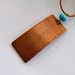 Copper leaf pendant, turquoise glass bead, leather thong, matching earrings.