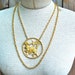 Aries zodiac necklace with stars and gold tone chain by Richelieu.