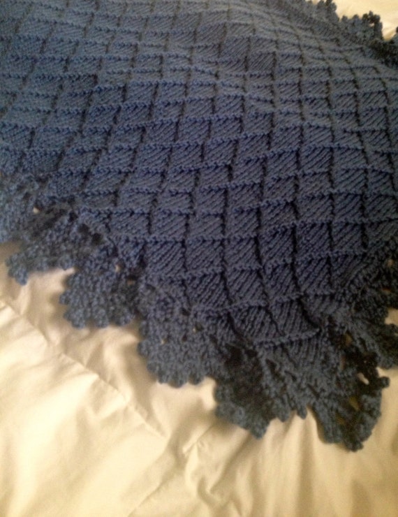 Hand knit baby blanket in diamond pattern with crocheted