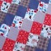 Snow Sports Themed Slate Blue and Red Flannel Lap Sized Quillow Blanket - The quilt that folds into a pillow