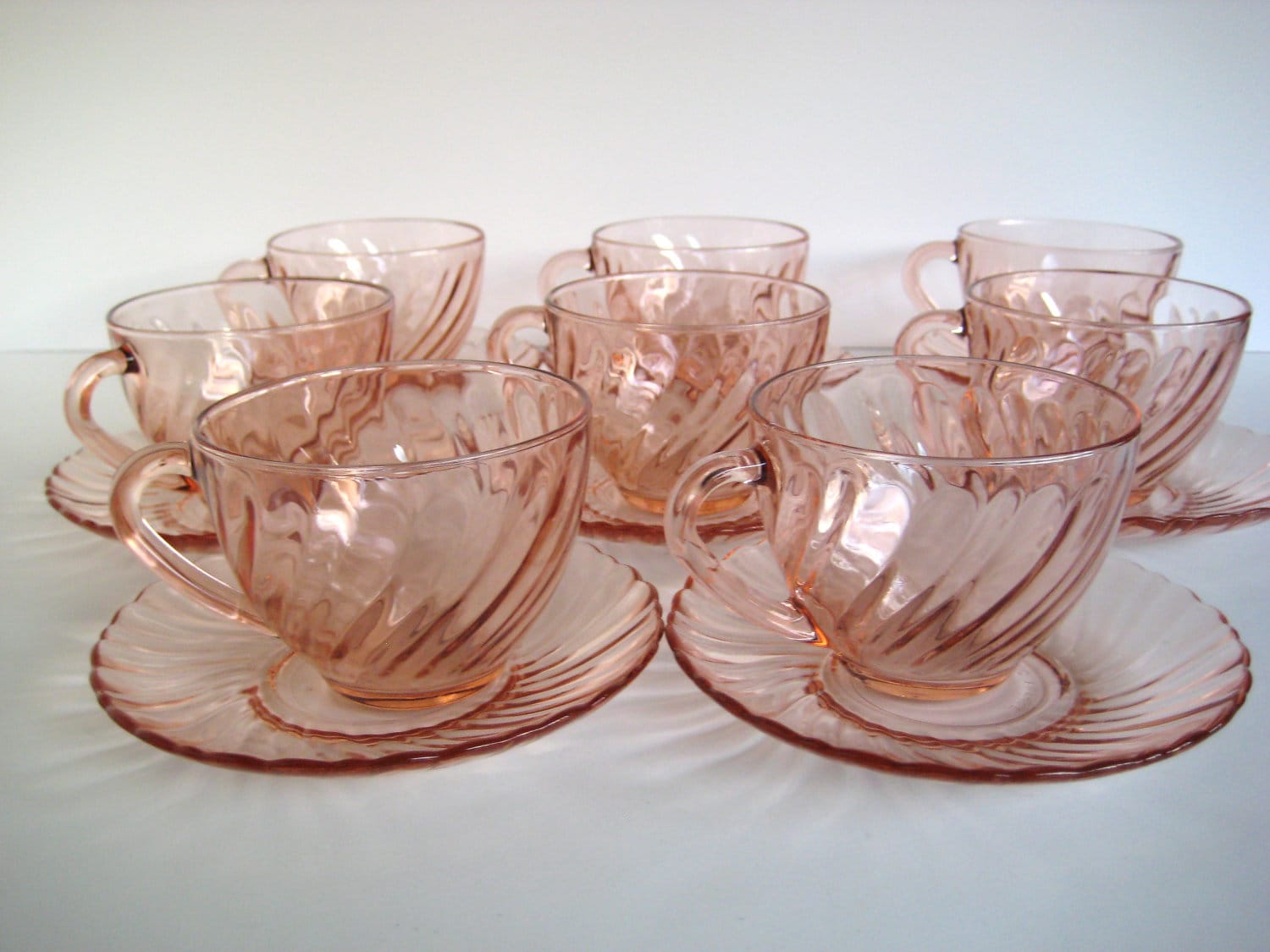 Eight Arcoroc France pink tea cups and saucers swirl