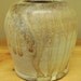 Carved Wood fired vase in natural ash glaze on porcelain clay..
