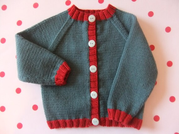 Hand knitted baby cardigan in dark teal and ruby red wool