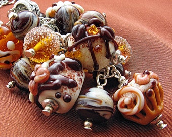 Chocolate, orange and creame colors glass lampwork pendant with cake-form beads
