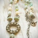 shabby chic rhinestone brass circle necklace. vintage assemblage on sterling with magnesite, faux pearls and vintage crystals by val b.