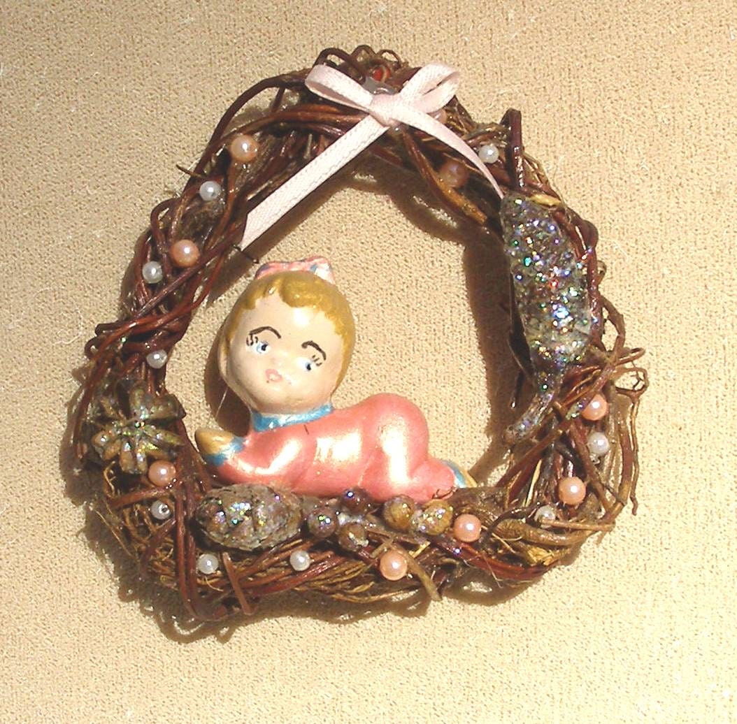 Baby girl in wreath tree ornament ceramic figurine