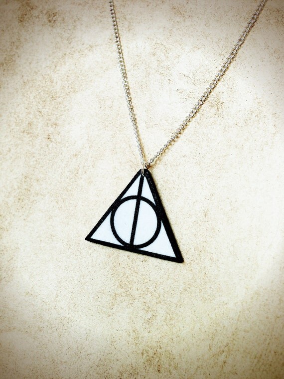 Items similar to Deathly Hallows triangle circle symbol