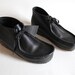 shoes women's 9 men's 7 black leather Clark's wallabees. high top. gummy soles.