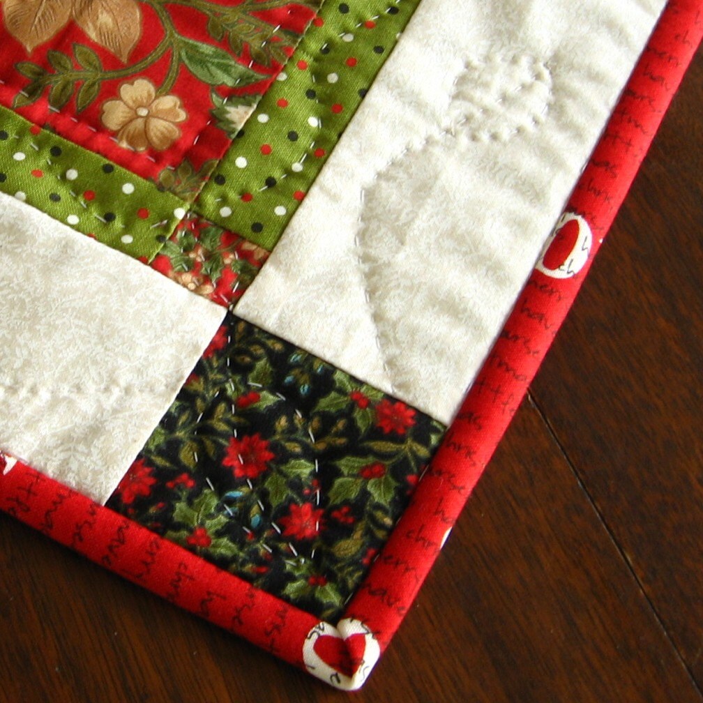 Hand quilted Christmas table mat Swiss Holiday for Moda red