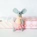 White mouse plush in matchbox bed patterned pink