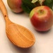 Curvy wooden spoon for stirring your sauce of salvaged plum wood