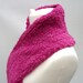 Pink scarf knitted in soft yarn.