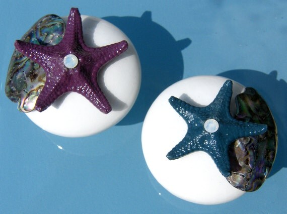 White Cabinet Knobs with Abalone shell pieces and knobby starfish in peacock blues and purples with opalescent accent.