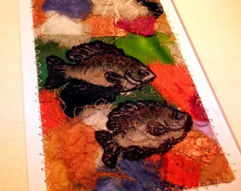 Matted fiber art, fish sketch on mixed-media abstract background