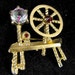 RESERVED: Spinning Wheel Figural Pin Gablonz Czech Iris Glass Rhinestone Old Piece