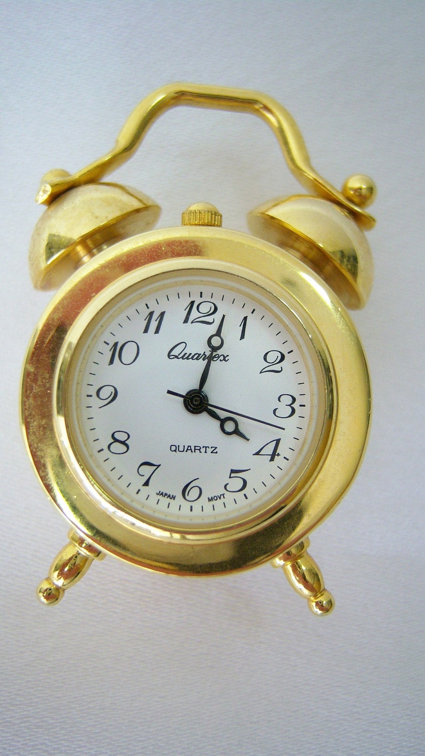 Small brass quartz alarm clock with battery