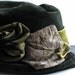 Stunning handmade hat by Langston Bourquin features Satin roses on green velour.